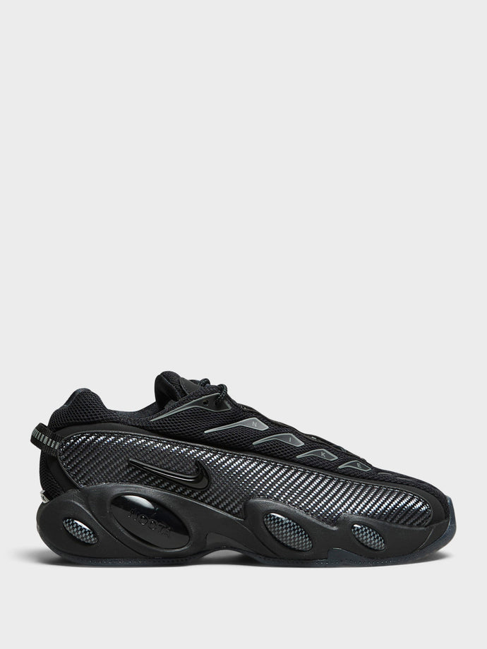 Nike - Nocta Glide Sneakers in Black, Black, Iron Grey and University Gold